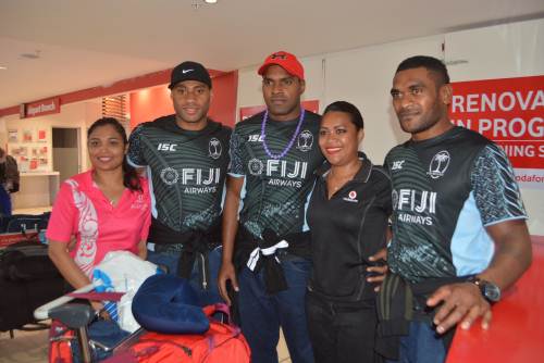 Fiji Airways 7s players Batinisavu Uluiyata, Josua Vakurunabuli and Vasikali Mudu with fans at Nadi Airport this morning. Picture: REINAL CHAND