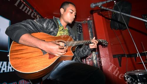 Togaliwaki Fuilakepa plays the guitar during the Taylor X-Man Tom Mawi Guitar Award competition at the Birdland Nightclub in Suva on Thursday night. Picture: RAMA