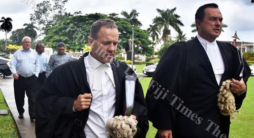 Lawyers Nick Barnes (left) and Wylie Clarke lead The Fiji Times publisher Hank Arts, The Fiji Times editor-in-chief Fred Wesley and Motibhai Group resident director Rajesh Patel outside the High Court in Suva yesterday. Picture: RAMA