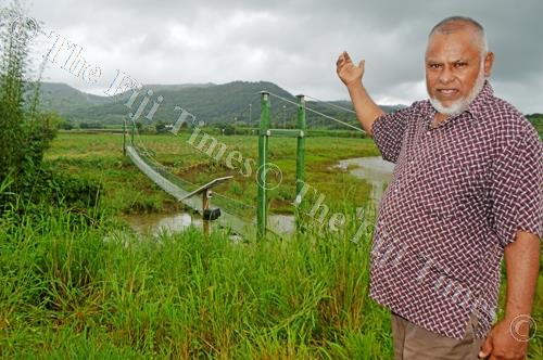 Mohammed Munaf Khan points at the slumped Nakorotari hanging bridge which has been closed to public. Picture: LUKE RAWALAI