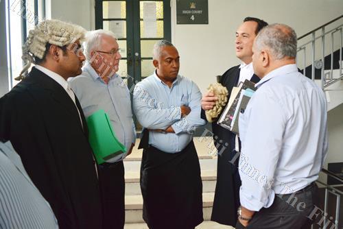 Lawyer Wylie Clarke (second from right) speaks to Fiji Times editor-in-chief Fred Wesley (centre) and Fiji Times general manager and publisher Hank Arts (second from left) outside the High Court in Suva yesterday. Picture: JOVESA NAISUA