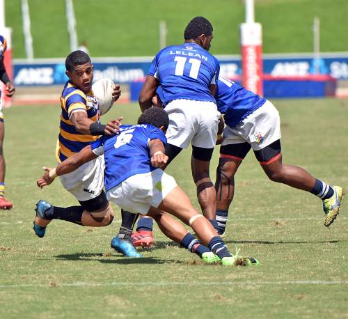 Peni Nanuku (left) of RKS attacks against Lelean during the secondary school U19 rugby league finals at the ANZ Stadium in Suva today. Picture: RAMA
