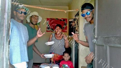 PYGMIES Youth Club members distibute food after cleaning up Lovu HART homes. Picture: SUPPLIED