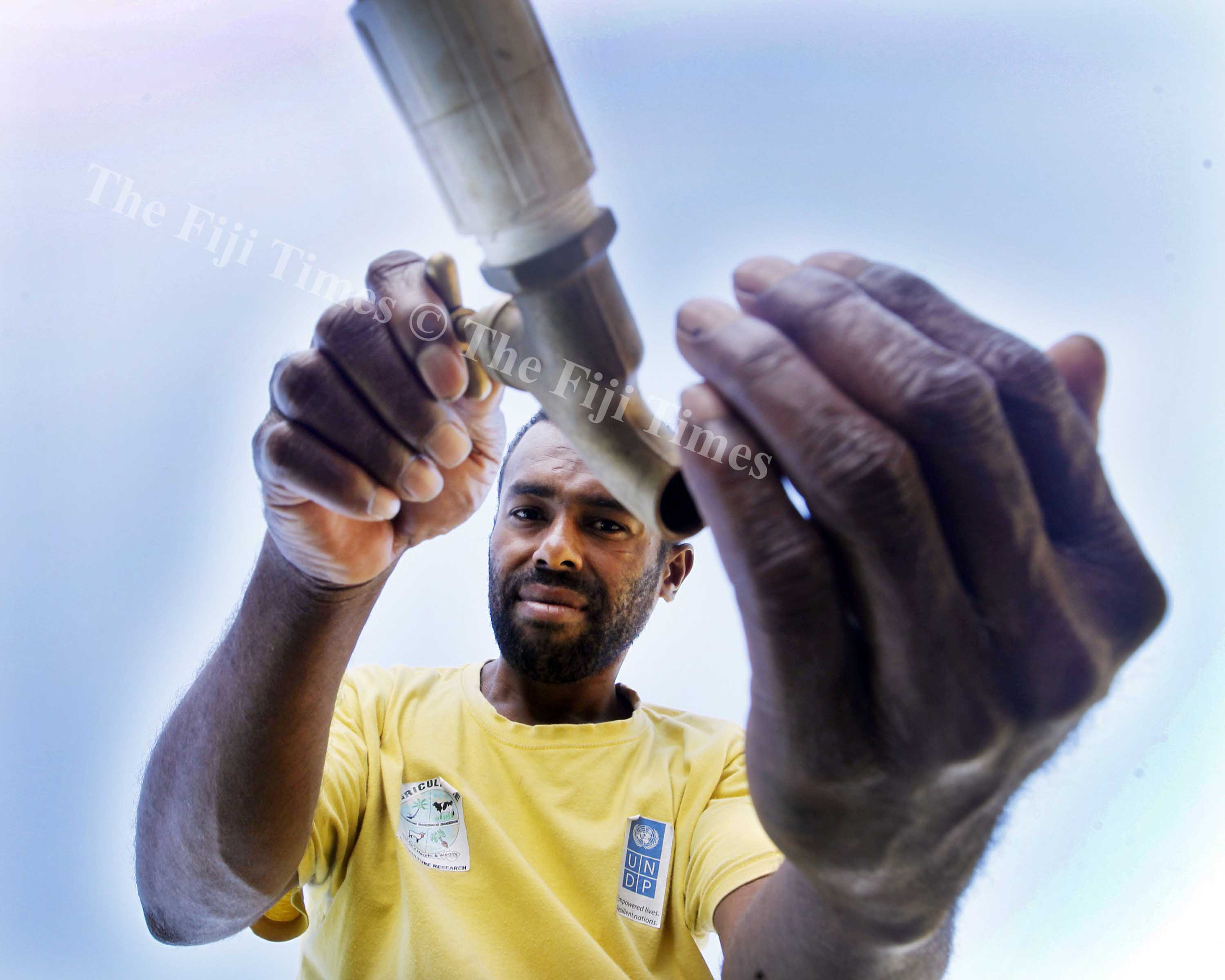 Usaia Toga the secretary of Bureiwai District school committee opened a empty tap due to the water cut yesterday. Picture ATU RASEA