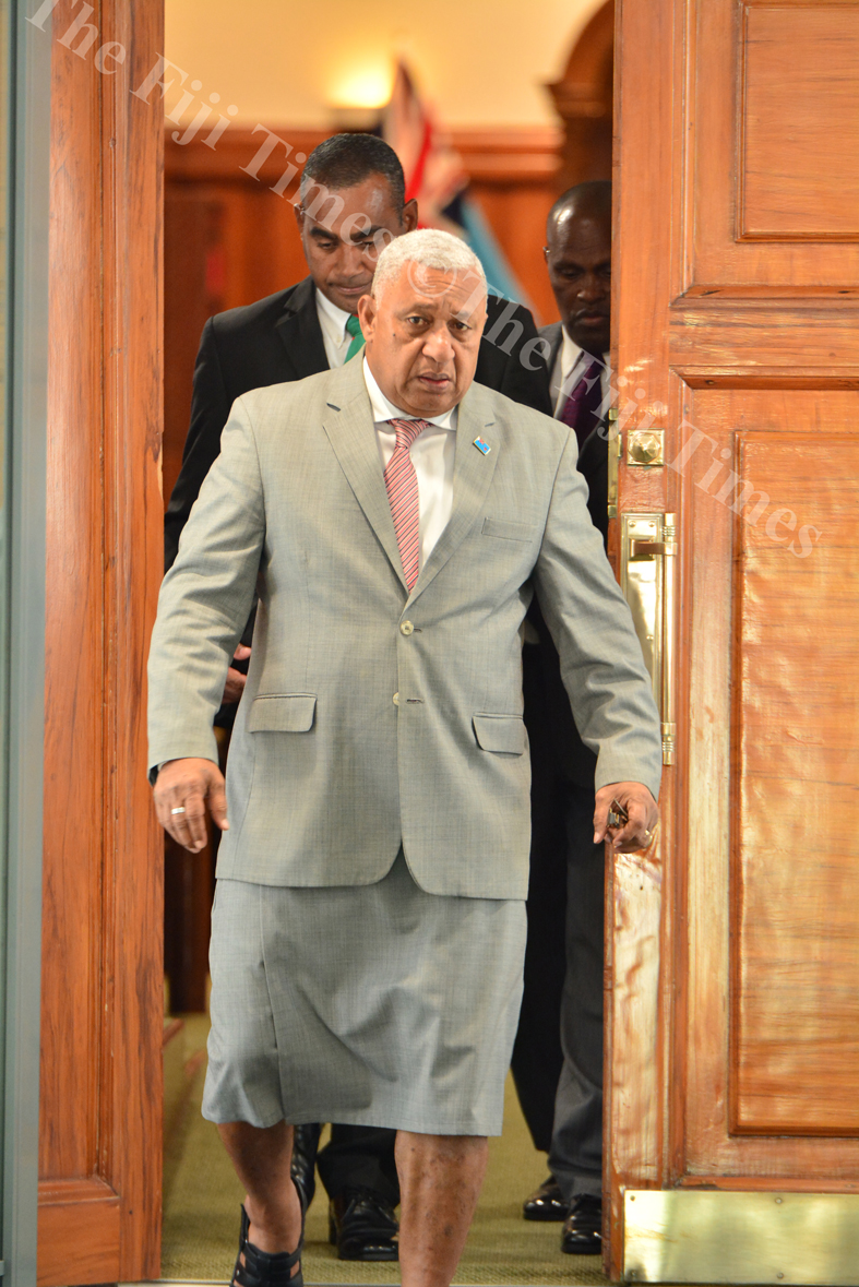 Prime Minister Voreqe Bainimarama leaving parliament with his body guards during a break in the sitting at the parliament complex in Suva yesterday. Picture: JOVESA NAISUA