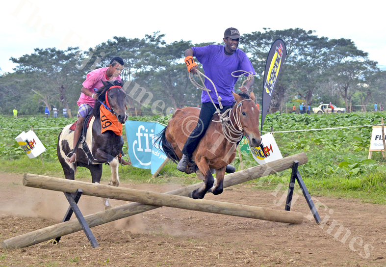 Horse owner and jockey Zinal Rahiman on his horse Don complete the last obstacle to win the Cross Country Race at the Sabeto Races in Nadi yesterday. Picture: REINAL CHAND