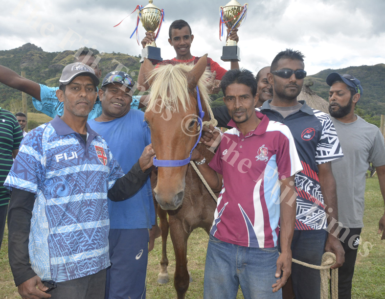 Mohammed Faruk (left) with his horse Tovolea joined family and friends pose for a photo after winning some races at the Sabeto Races in Nadi. Picture: REINAL CHAND