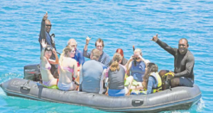 South Sea sailing vessel Sabre passengers with crew members TaitusiQoro, left, and Saki Latia on a snorkelling trip. Picture: BALJEET SINGH