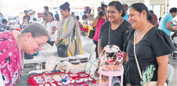 Sedula Devi and daughter Simran Prasad serve US Ambassador to Fiji, Marie Damour. Picture: JOSEFA SIGAVOLAVOLA