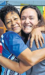 Litea Savuiwasa, left, embraces Katy Pakinga during her visit distributing food items during the flood in Nadi last week. Picture: SUPPLIED