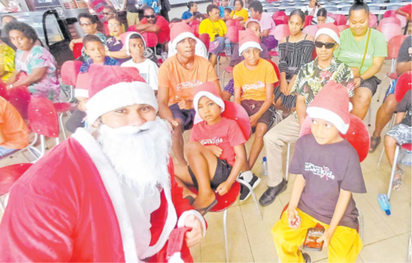 Santa Claus with children from WOWS Kids Fiji at MHCC in Suva yesterday. Picture: DIONISIA TABUREGUCI.