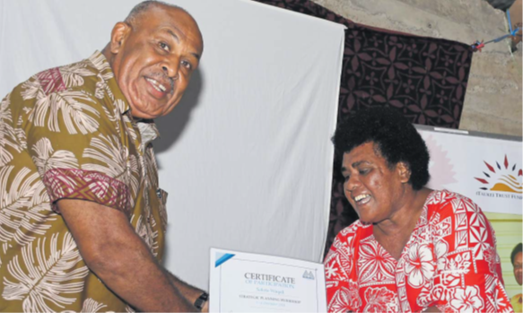 Minister for iTaukei Affairs Ifereimi Vasu hands over the Certificate of Participation on Strategic Planning Workshop to Salote Waqali at Toge village, Ba. Picture: BALJEET SINGH