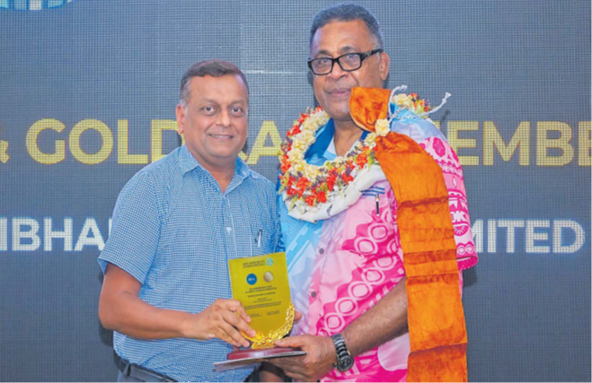 Motibhai Group executive director Nilesh Patel, left, receives the Gold Card certificate from Assistant Minister of Finance Esrom Immanuel. Picture: SUPPLIED