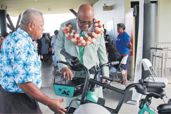 DPM and Minister for Trade Manoa Kamikamica, wearing garland, inspects a bike owned by Qaqi Mai at the World Consumer Rights Day event held at Albert Park in Suva yesterday. Picture: SUPPLIED