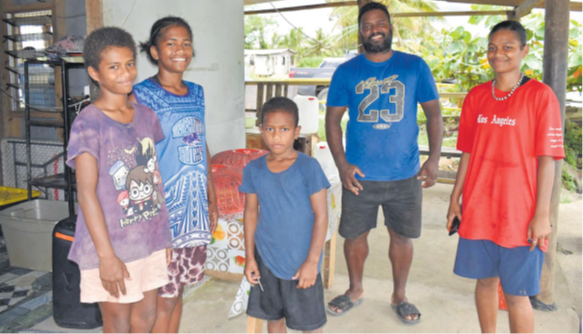Leone Nabaraki and his children pose in front of their shop at Nasali Landing in the Rewa delta. Picture: LENAITASI CAVUILATI