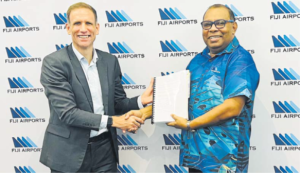 Collins Aerospace Singapore Global Director of Business Development - Airports SteveRobinson and Fiji Airports CEO Mesake Nawari shake hand after signing the $17.5m
deal at the Fiji Airports headquarters in Nadi on June 12.
Picture: SUPPLIED/FIJI AIRPORTS