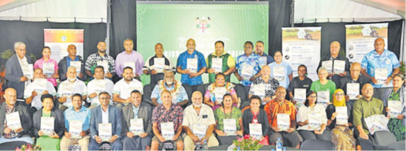 Acting Minister for Agriculture Alitia Bainivalu and Assistant Minister Tomasi Tunabuna pictured with farmers, stakeholders and experts with a copy of the new 10-year policy. Picture: MINISTRY OF AGRICULTURE