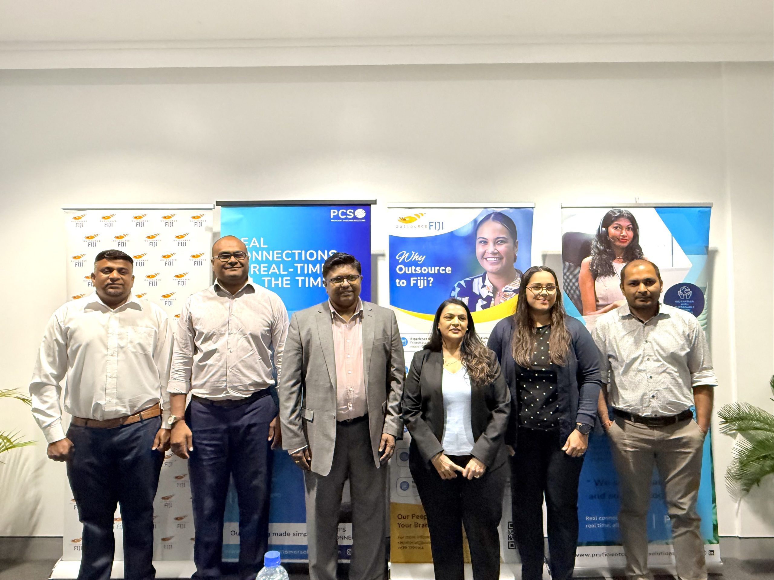 (L-R) Outsource Fiji executive director Josefa Wivou (2nd from left), PCS founder and director Yogesh Chand (3rd from left) and PCS co-founder Sangita Chand (forth from left) with staff members of PCS at a media briefing in Suva. Picture: JOSEFA SIGAVOLAVOLA