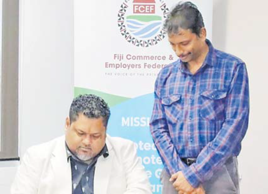 Pradeep Menon, the Second Secretary (Consular & Commerce) of the Indian High Commission in Fiji bears witness to the signing of the MoU by FCEF CEO Edward Bernard. Picture: SUPPLIED