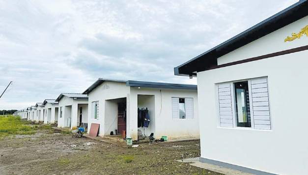 Minister defends housing lot prices